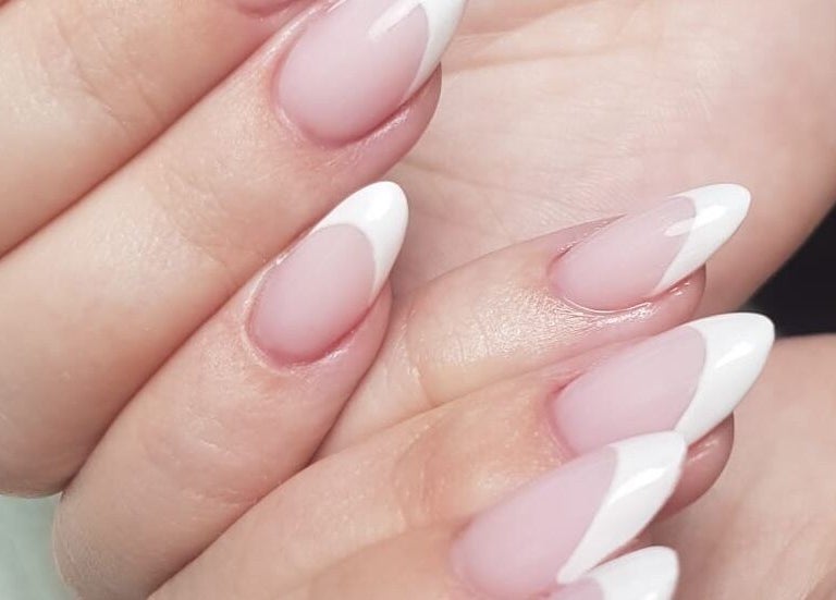 Classic French manicure at Harmony Nail Studio in Freeport, Freeport, BS, showcasing elegant nail artistry.