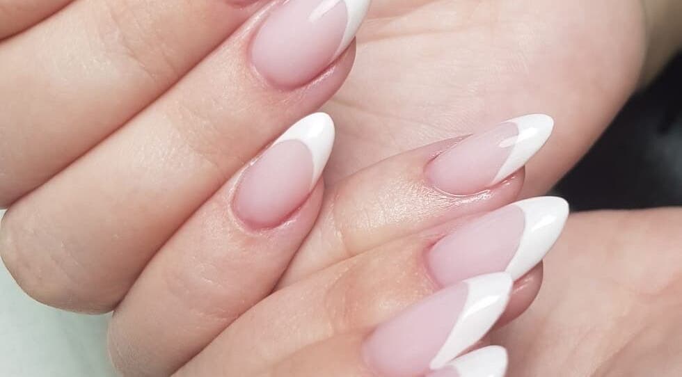 Classic French manicure at Harmony Nail Studio in Freeport, Freeport, BS, showcasing elegant nail artistry.