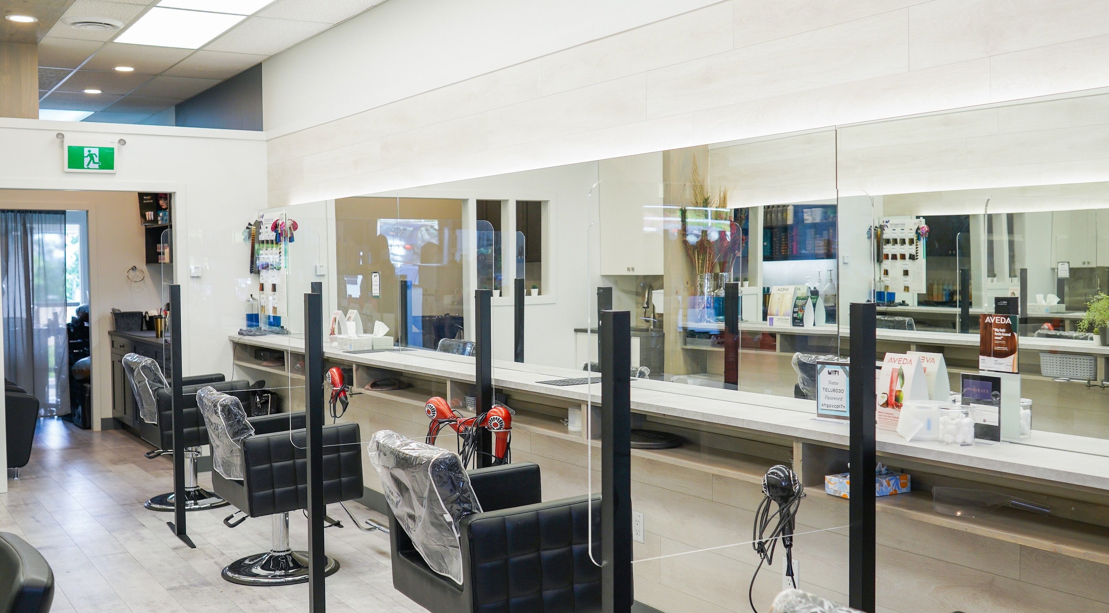 Spacious interior of L'Atelier Grace Hair Salon in Burnaby, British Columbia, CA featuring stylish styling chairs.