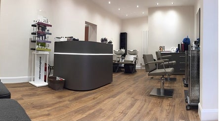 Modern salon interior at Saiqs Hair and Beauty, London, England, GB, featuring stylish seating and decor.