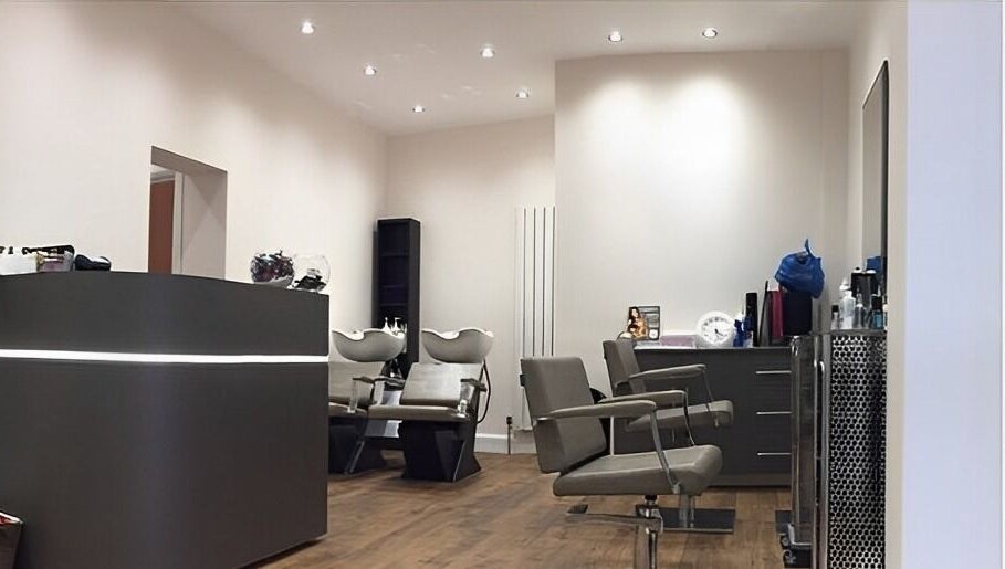 Contemporary salon at Saiqs Hair and Beauty, London, England, GB. Features modern chairs and washing stations.