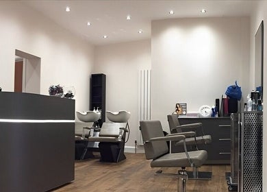 Contemporary salon at Saiqs Hair and Beauty, London, England, GB. Features modern chairs and washing stations.