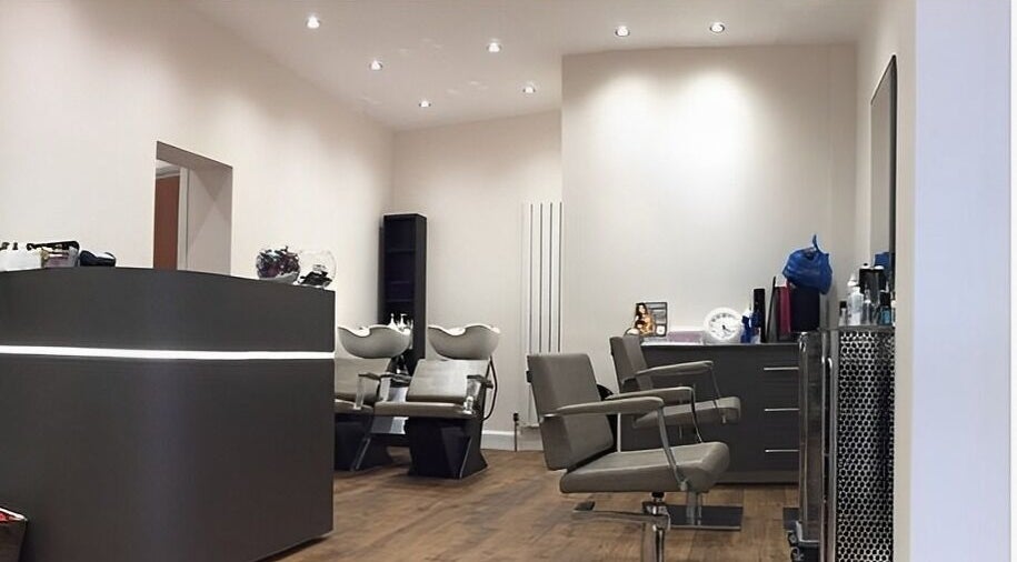 Contemporary salon at Saiqs Hair and Beauty, London, England, GB. Features modern chairs and washing stations.