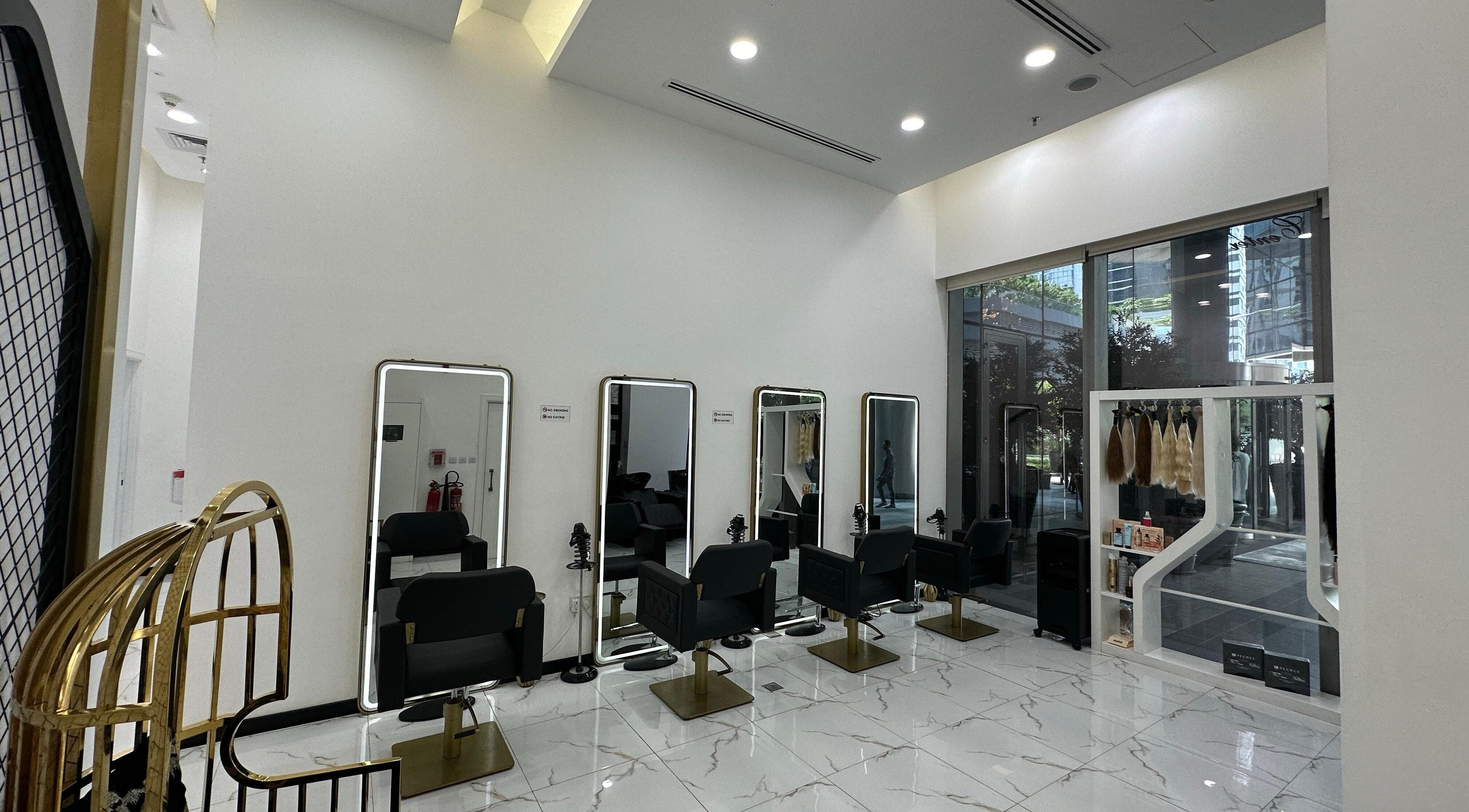 Modern salon interior at On The Go Beauty Center in Dubai, AE with sleek styling chairs and mirrors.