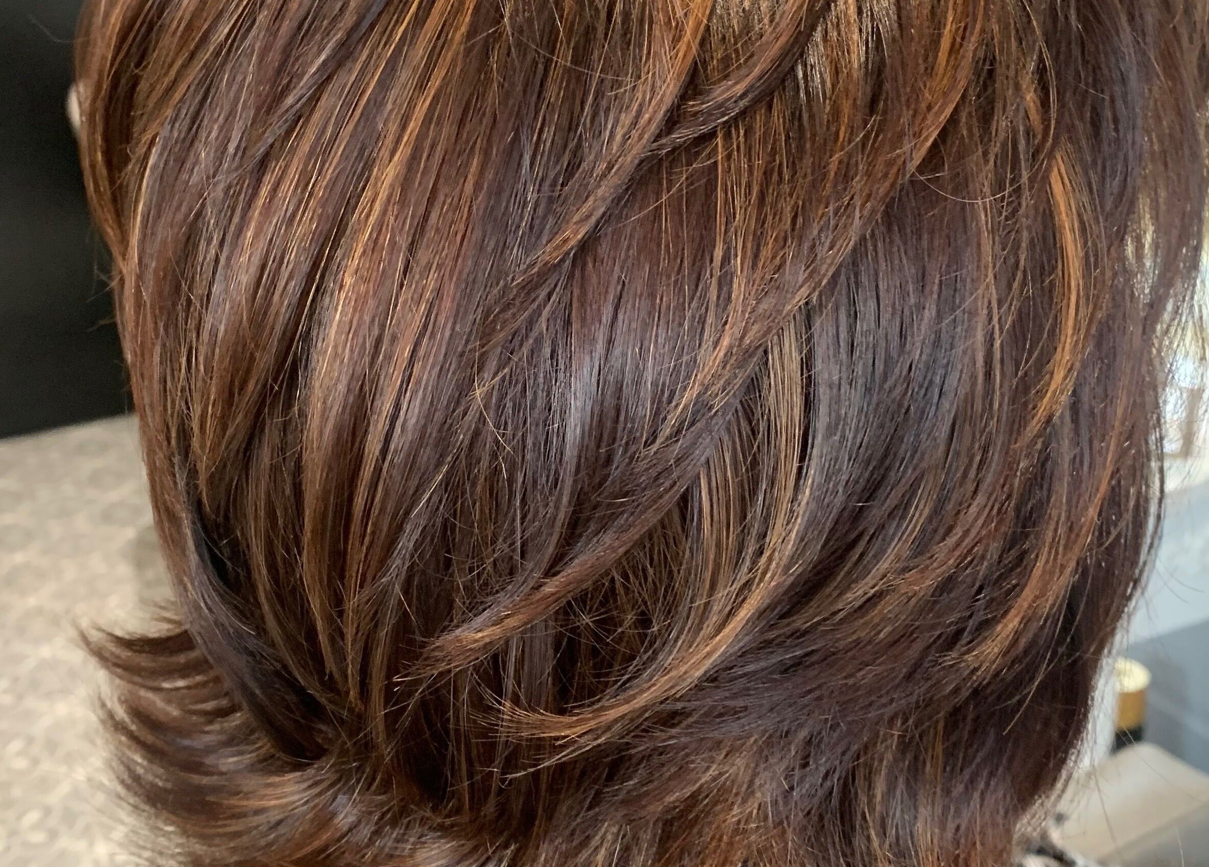 Stylish layered haircut at Hair At 25 in Dungannon, Northern Ireland, GB, showcasing shiny brown hair.