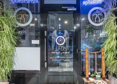 Entrance of Reflexions Bayswater in London, England, GB, with lush greenery and welcoming decor.