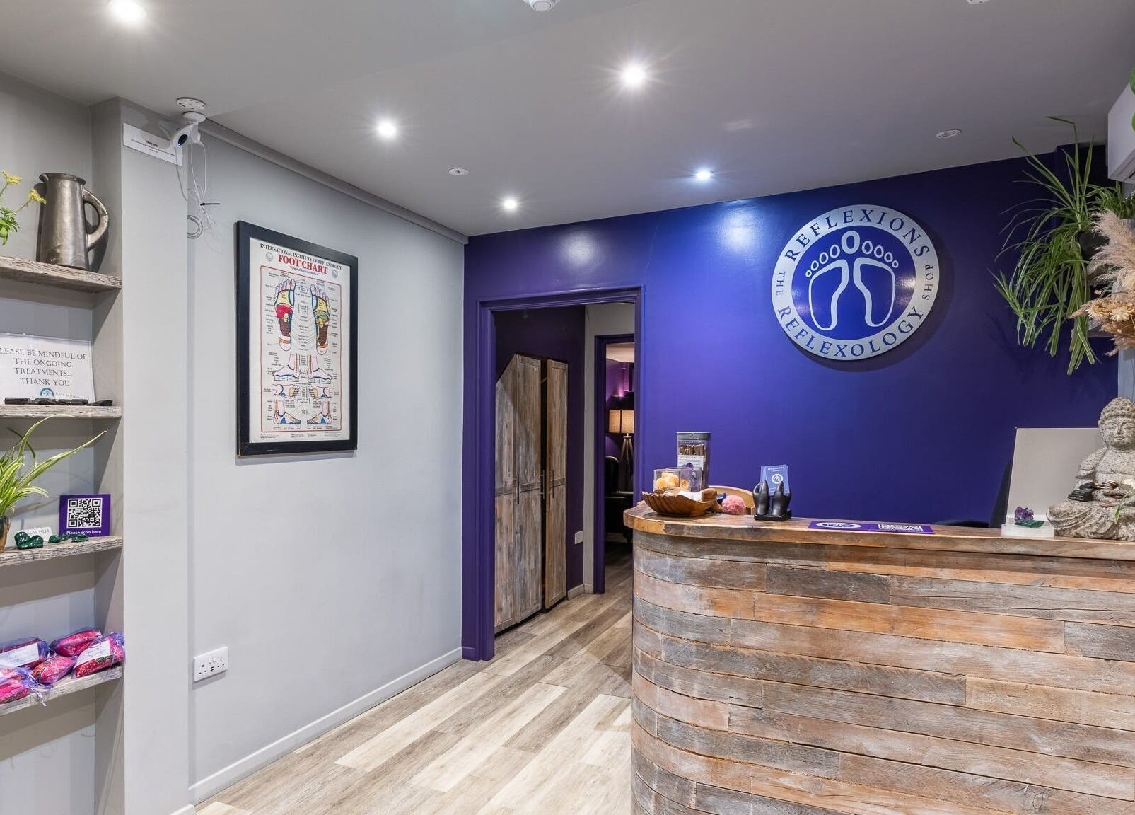 Reflexions Bayswater reception area featuring a rustic wooden desk and calming decor in London, England, GB.