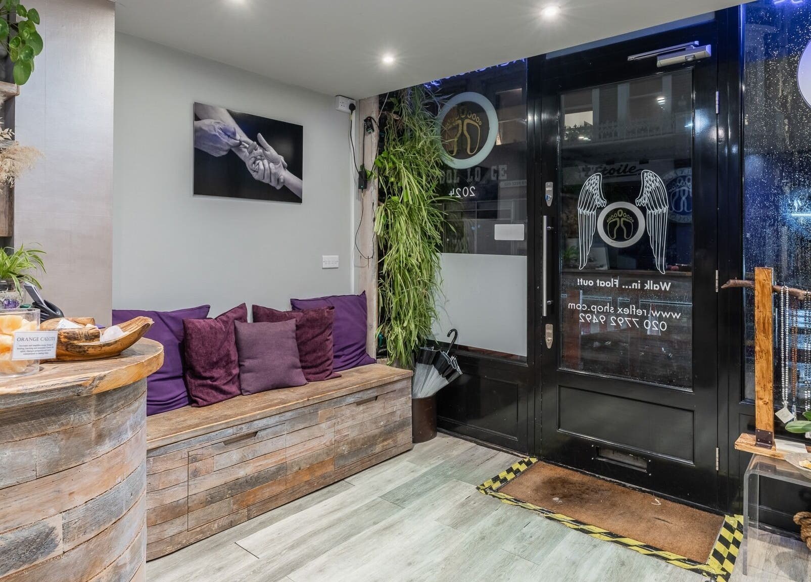 Reception area of Reflexions Bayswater, London, England, GB with cozy seating and rustic decor.