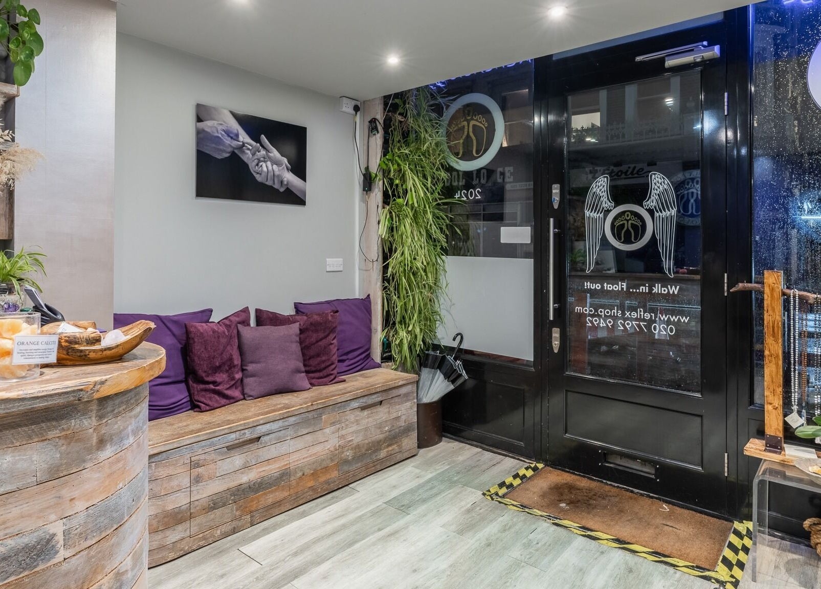 Reception area of Reflexions Bayswater, London, England, GB with cozy seating and rustic decor.