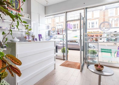 Inviting interior of Reflexions Clapham with lush plants and bright decor, located in London, England, GB.