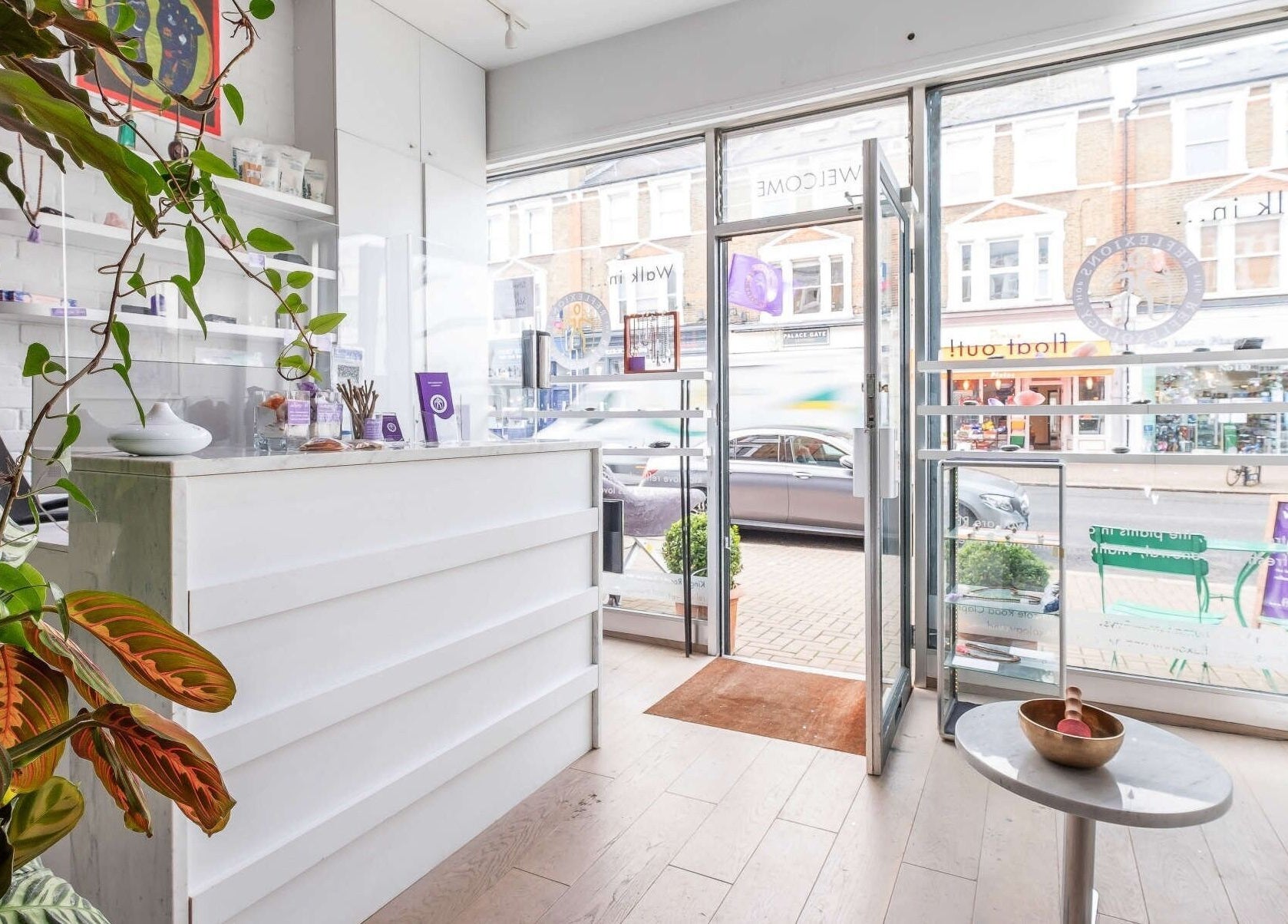 Inviting interior of Reflexions Clapham with lush plants and bright decor, located in London, England, GB.
