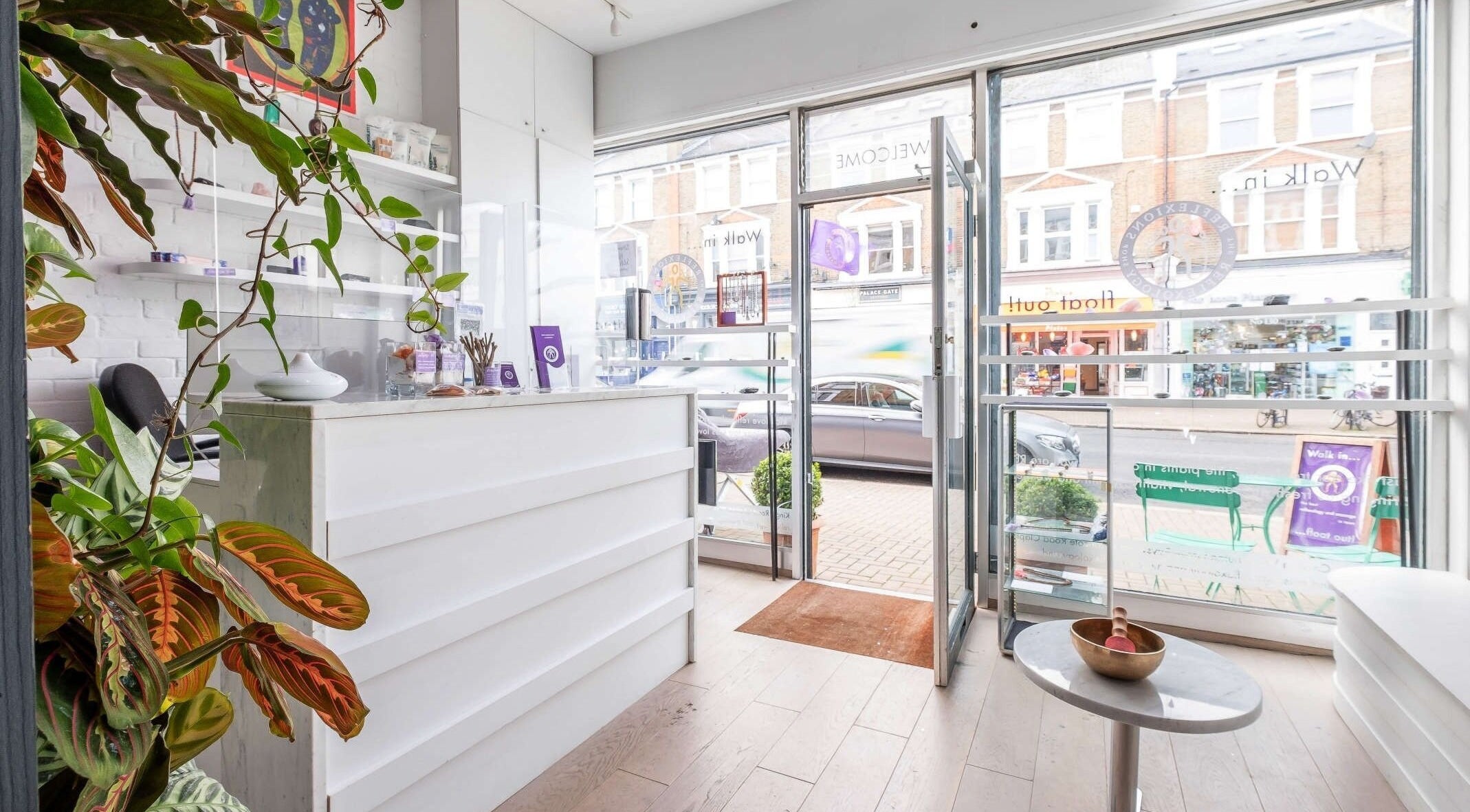 Inviting interior of Reflexions Clapham with lush plants and bright decor, located in London, England, GB.