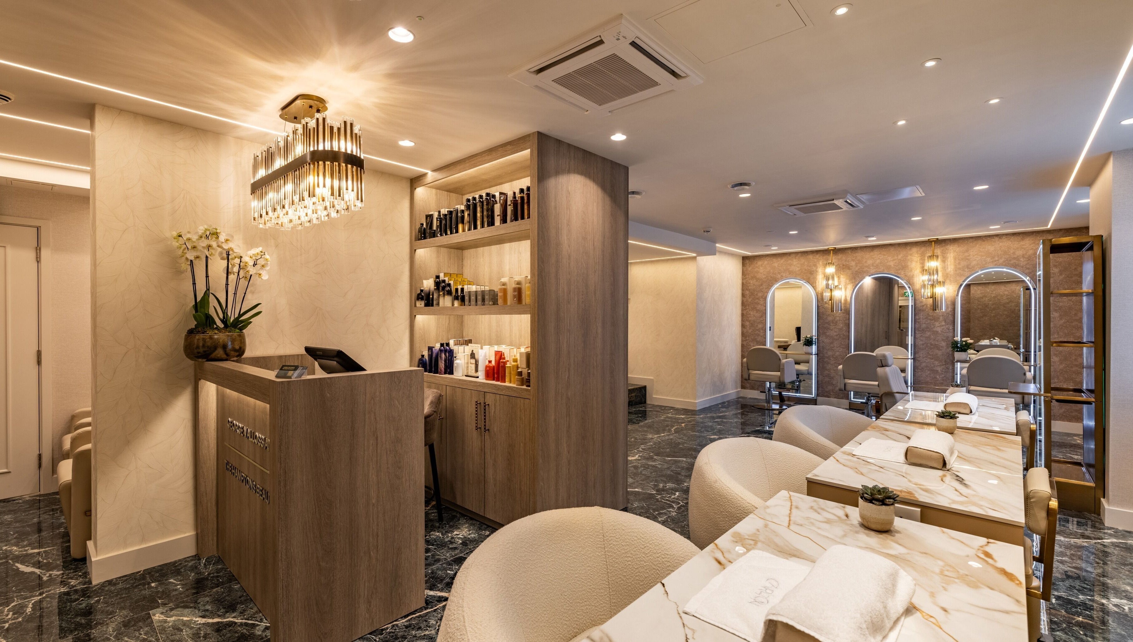 Luxurious interior of The Hamptons Nails & Beauty in London, England, GB with elegant decor and modern seating.