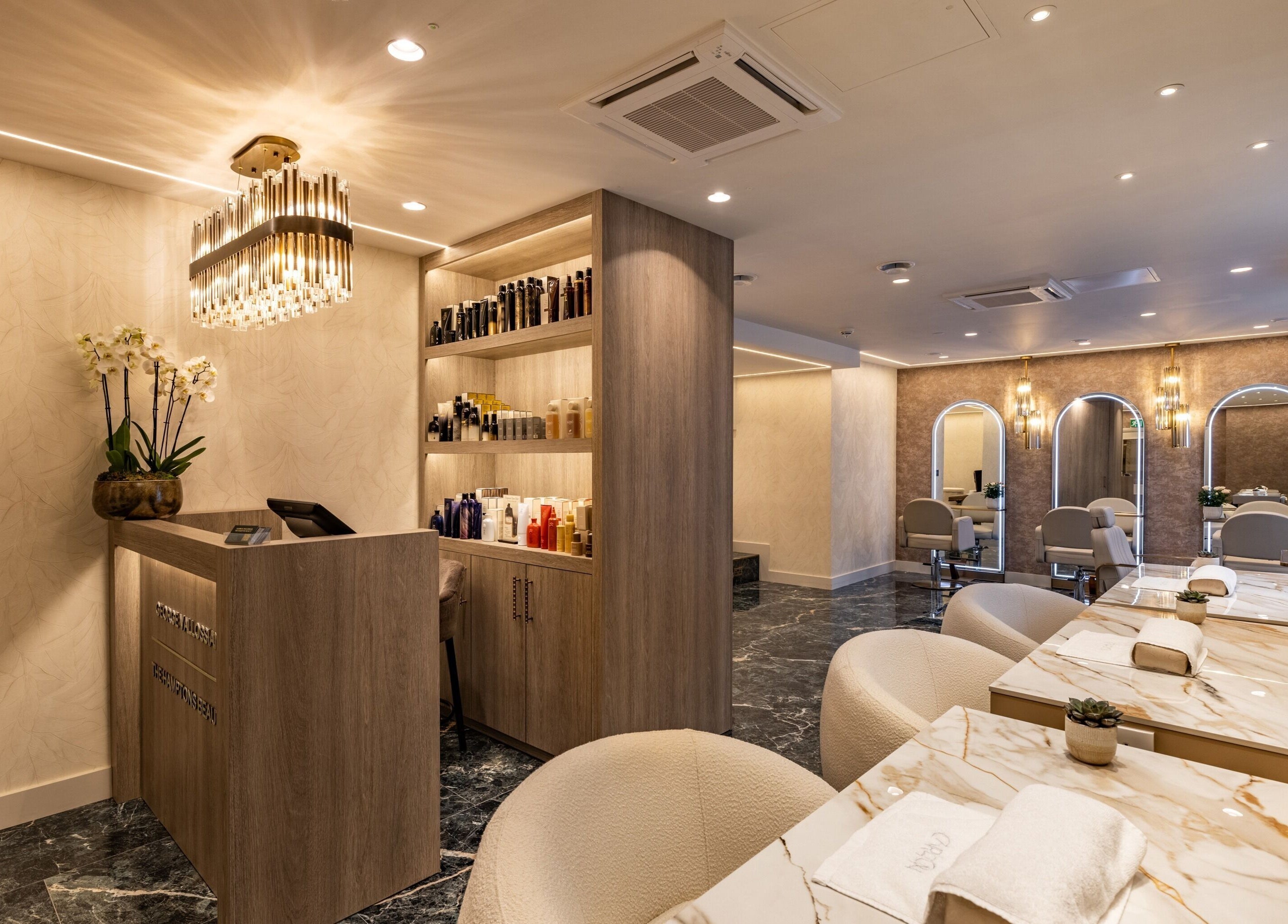 Luxurious interior of The Hamptons Nails & Beauty in London, England, GB with elegant decor and modern seating.