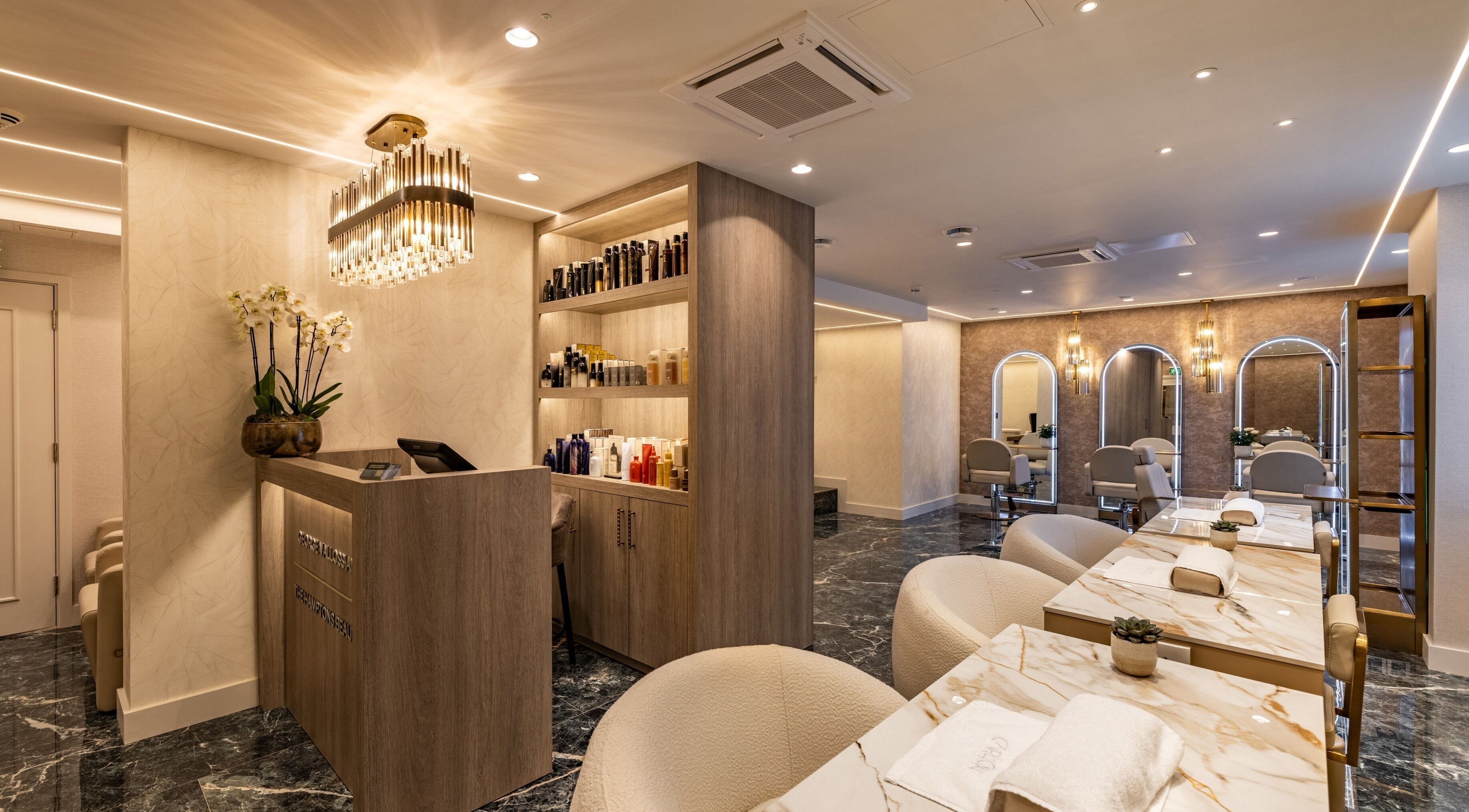 Luxurious interior of The Hamptons Nails & Beauty in London, England, GB with elegant decor and modern seating.