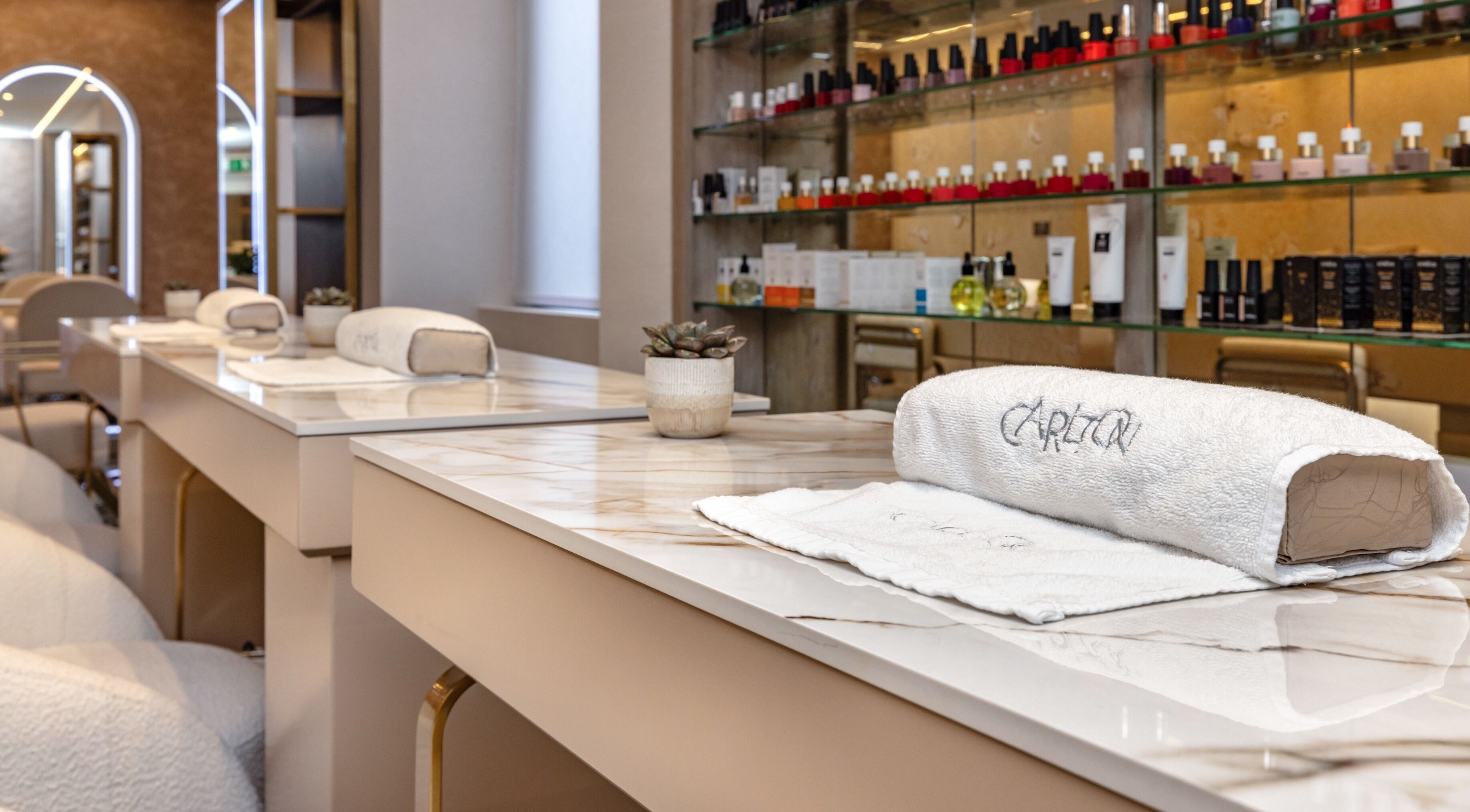 Elegant nail station at The Hamptons Nails & Beauty, London, England, GB, featuring luxurious decor and products.