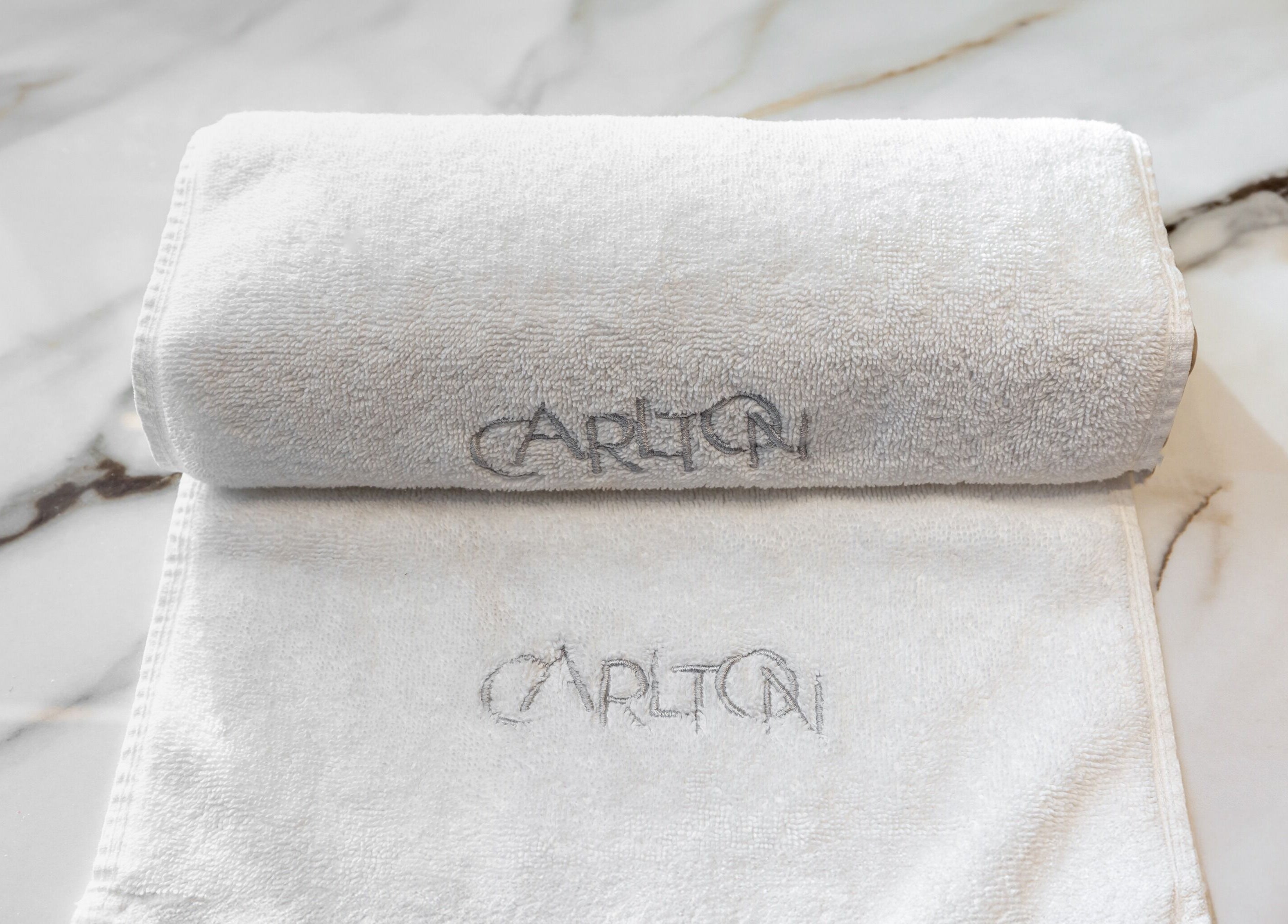 Elegant white towels at The Hamptons Nails & Beauty, London, England, GB enhancing luxury spa experience.