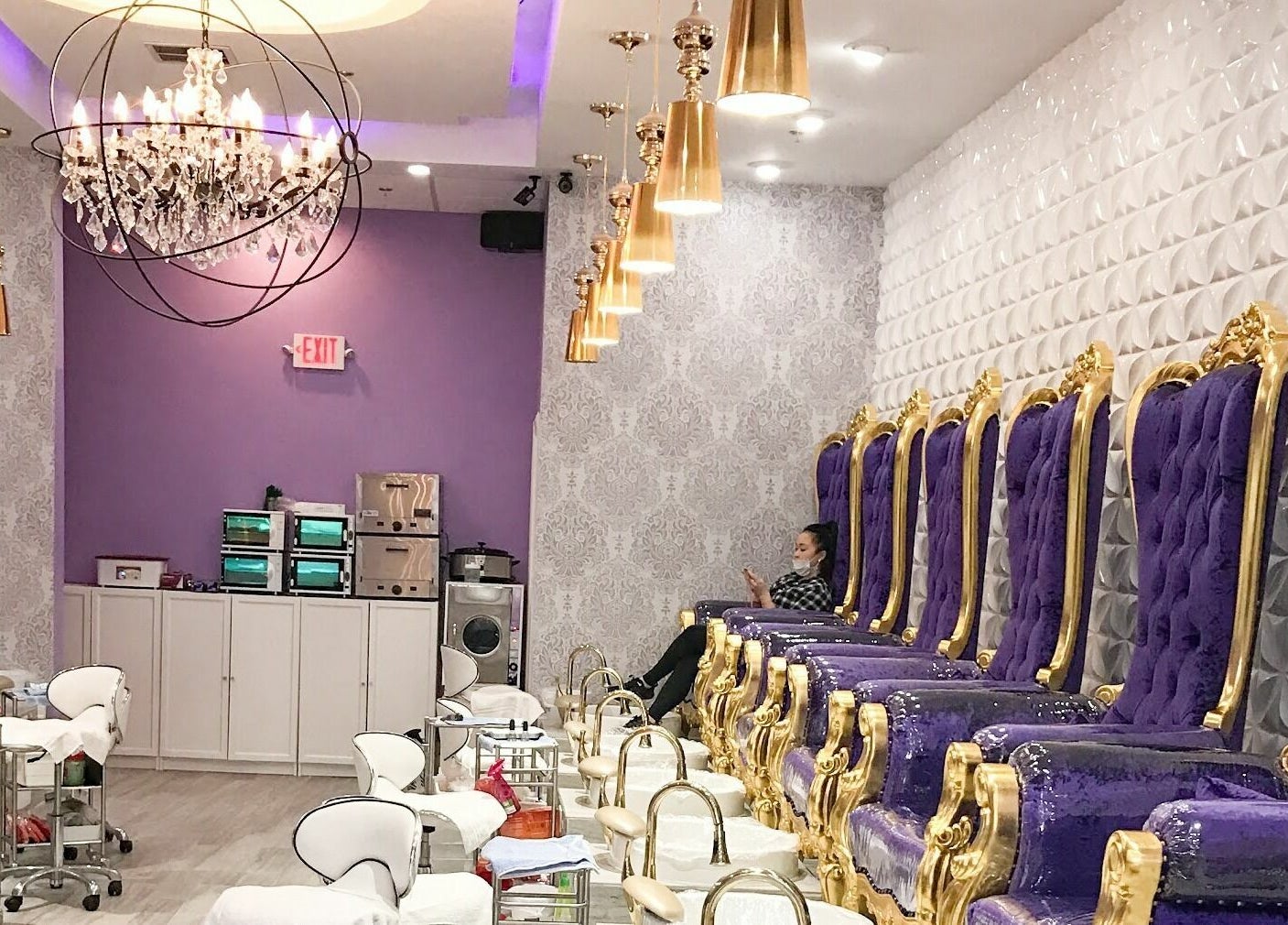 Luxurious nail treatment area at The Nail Place in Evergreen Park, Illinois, US with purple velvet chairs.