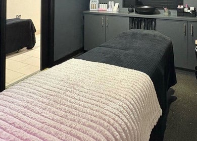Elegant treatment room at House of Luxxe Beauty Salon, Yate, England, GB, featuring a cozy bed.