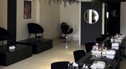 Interior of House of Luxxe Beauty Salon, Yate, England showcasing chic seating and modern décor.