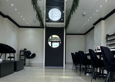 Chic interior of House of Luxxe Beauty Salon in Yate, England, GB with modern decor and seating.