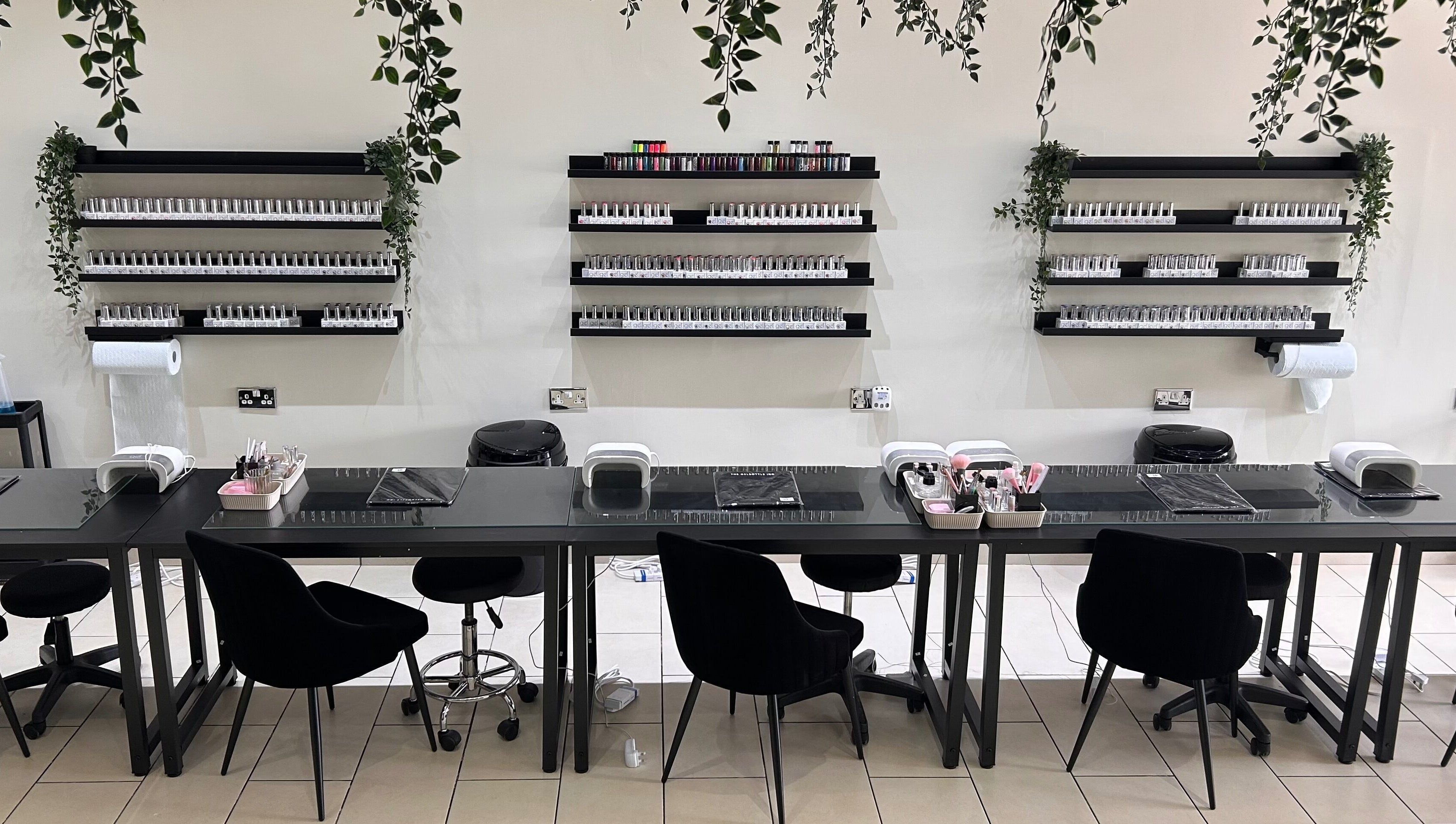 Modern nail station at House of Luxxe Beauty Salon, Yate, England, GB, featuring organized polish displays.