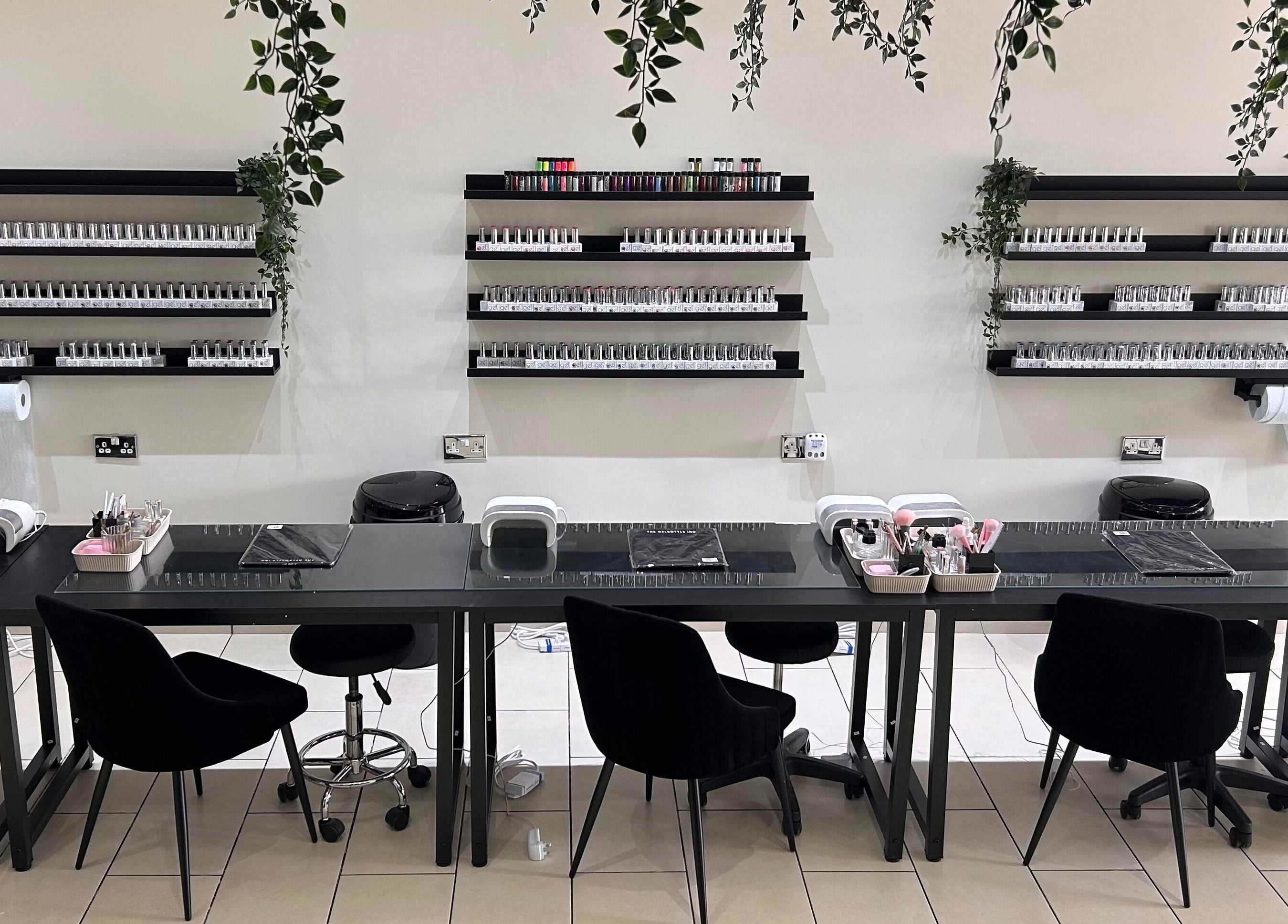 Modern nail station at House of Luxxe Beauty Salon, Yate, England, GB, featuring organized polish displays.