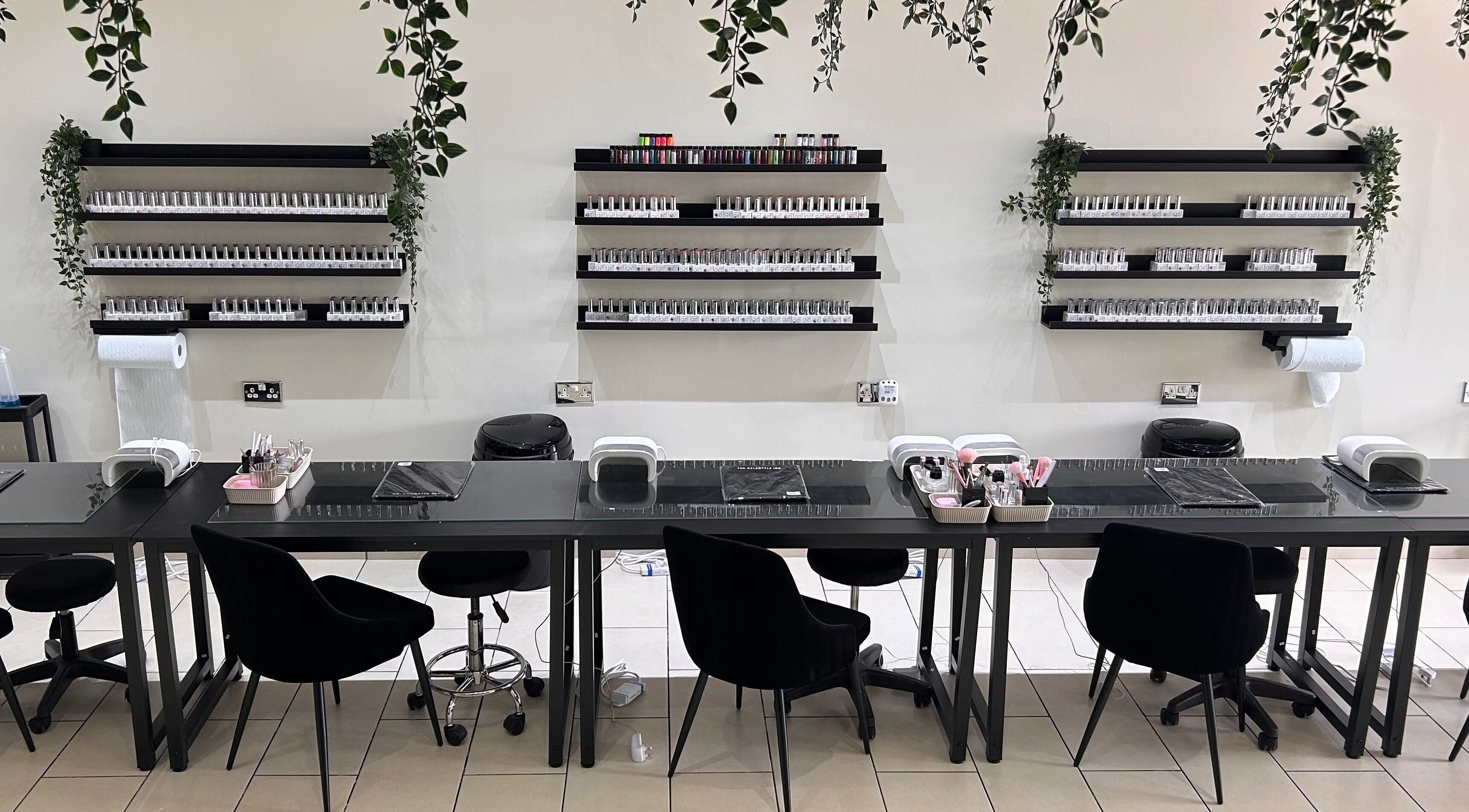 Modern nail station at House of Luxxe Beauty Salon, Yate, England, GB, featuring organized polish displays.