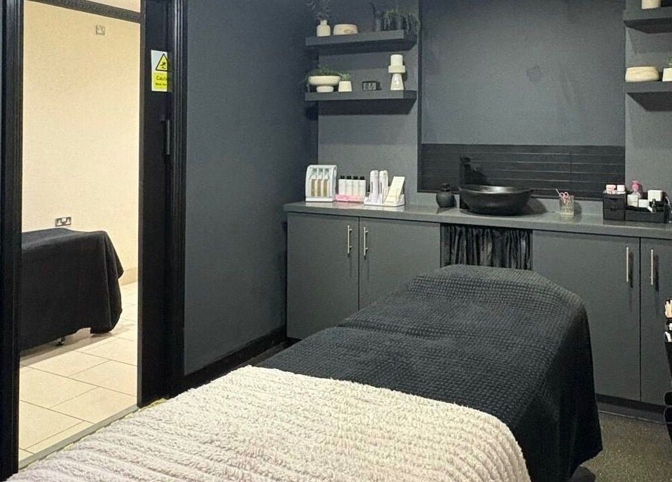 Relaxing treatment room at House of Luxxe Beauty Salon, Yate, England, GB with sleek grey decor.
