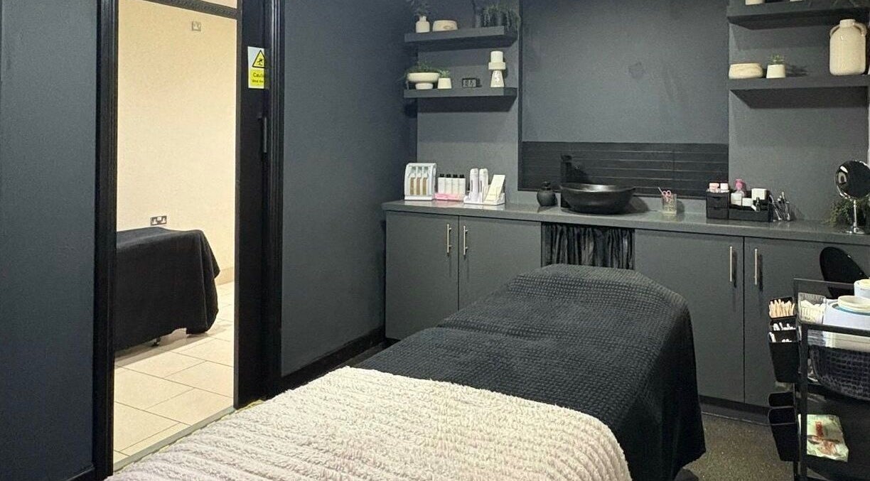 Relaxing treatment room at House of Luxxe Beauty Salon, Yate, England, GB with sleek grey decor.