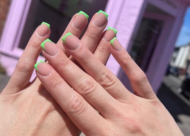 Stylish neon green French manicure at Glam’d by Sisanda, Rushden, England, GB.