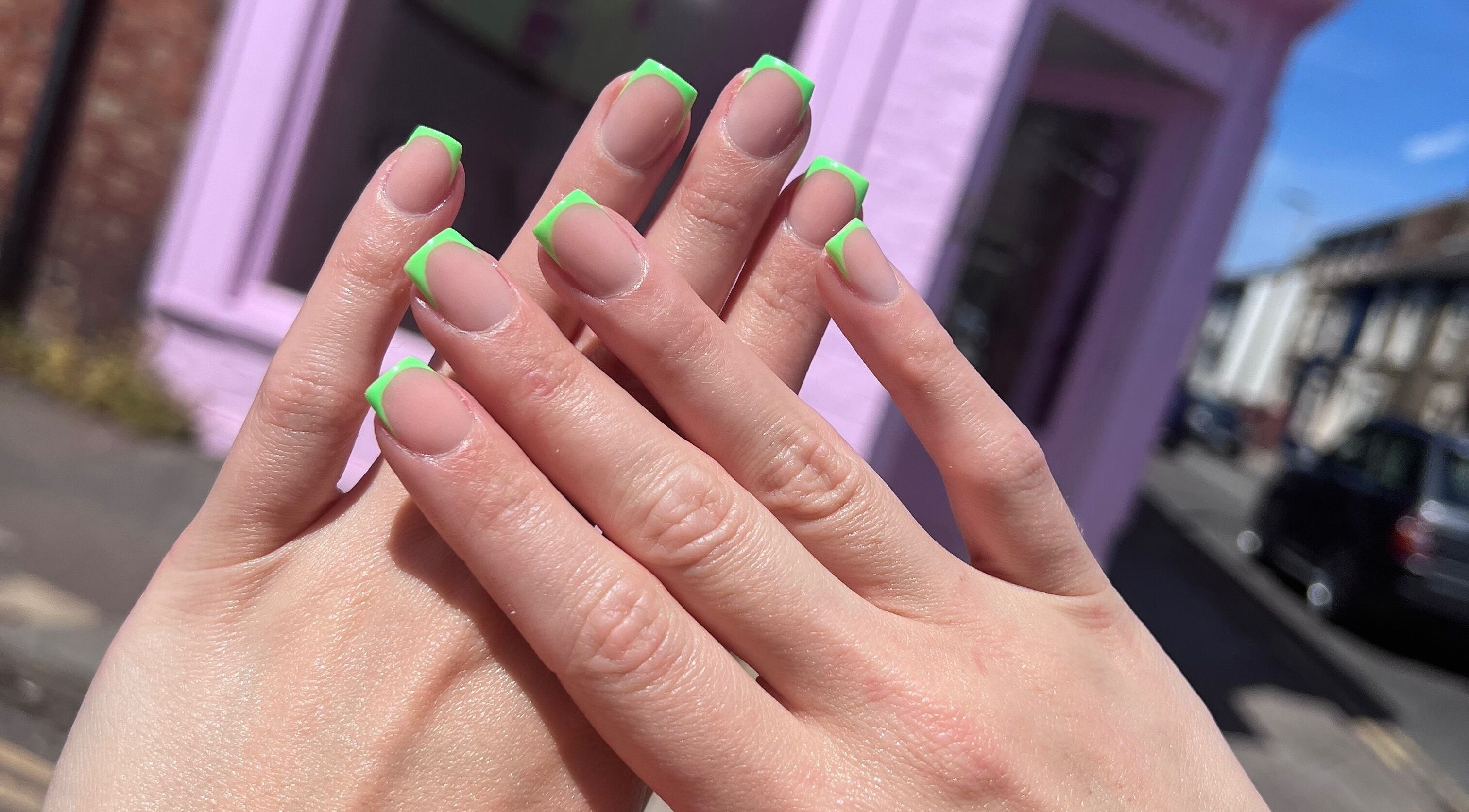 Stylish neon green French manicure at Glam’d by Sisanda, Rushden, England, GB.