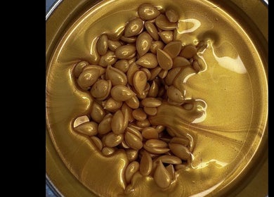 Gold-toned beauty serum from Fresca Beauty, Toronto, Ontario, CA in a glossy, inviting texture.