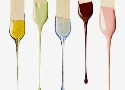 Vibrant wax colors dripping from sticks at W.E. WAX, Arima, Arima Borough Corporation, TT.