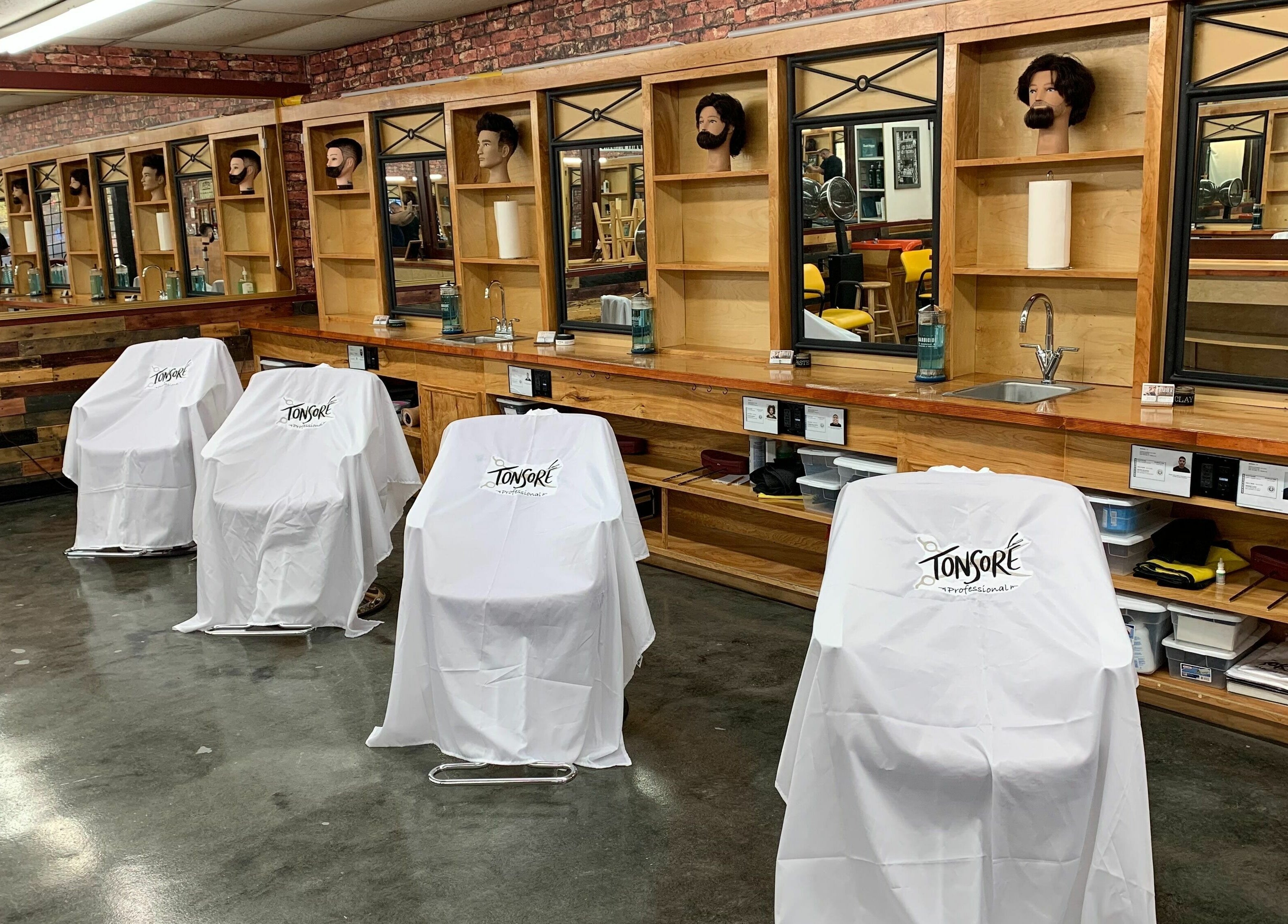 Tonsore Master Academy salon stations with mirrors and chairs in San Antonio, Texas, US.