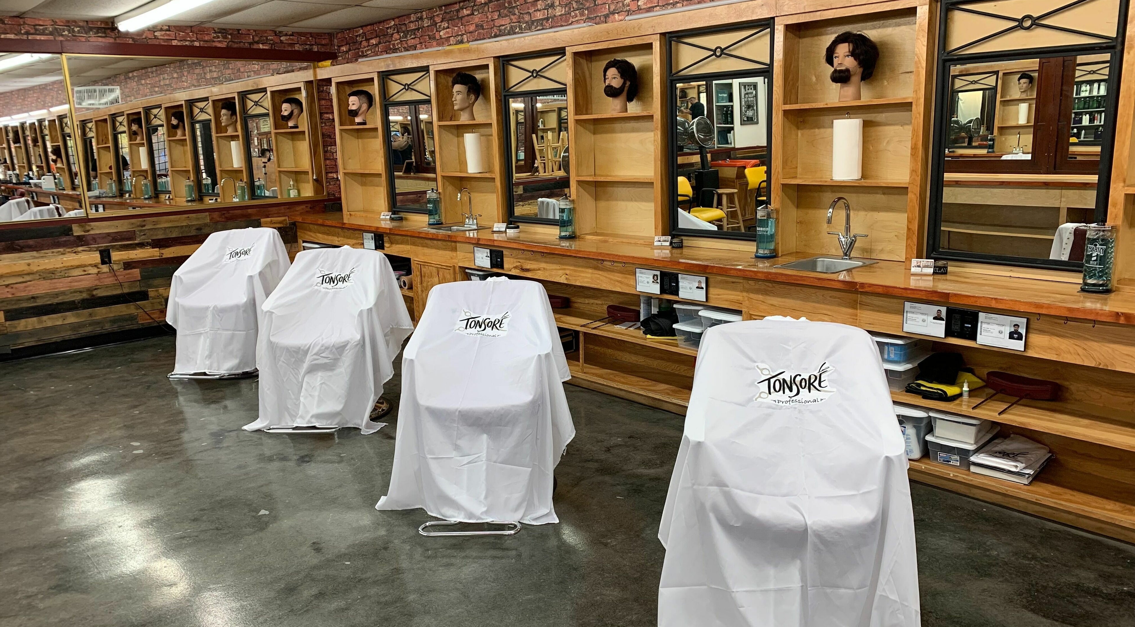 Tonsore Master Academy salon stations with mirrors and chairs in San Antonio, Texas, US.
