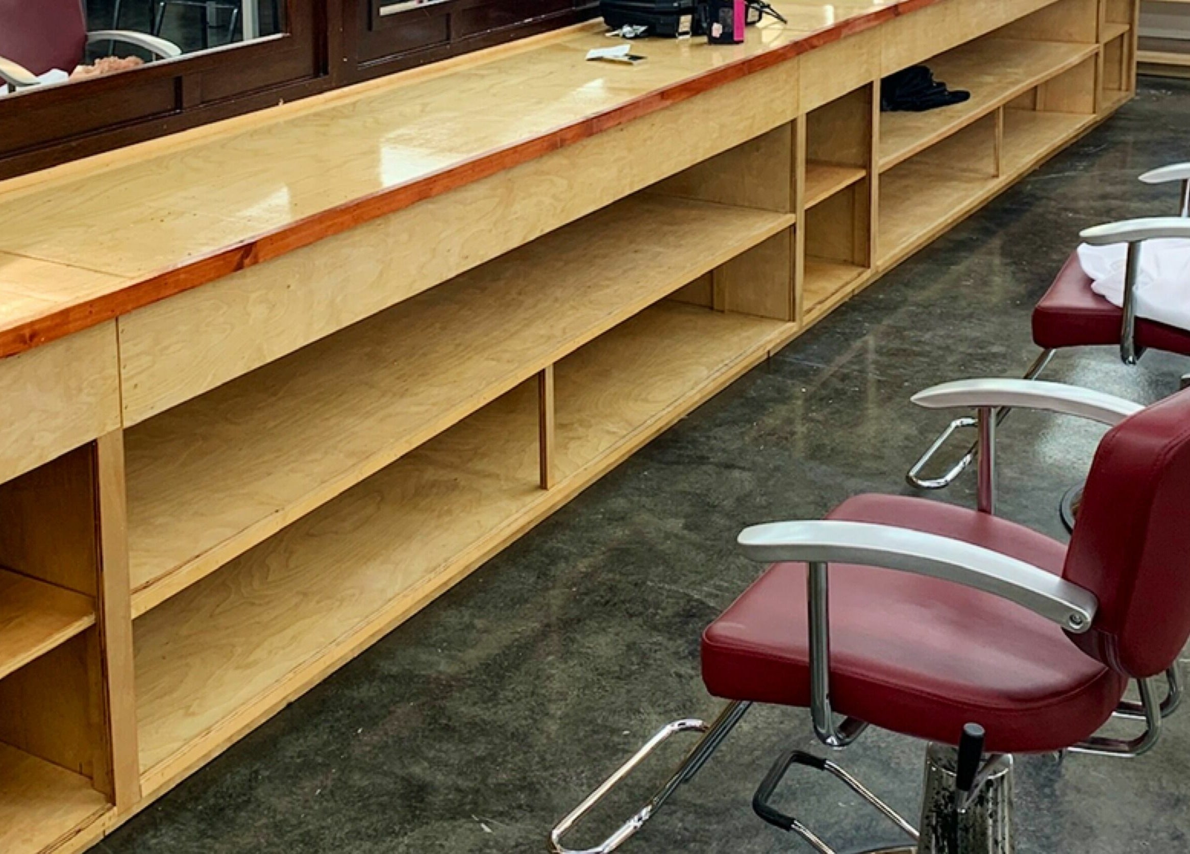Modern salon chairs and wooden workspace at Tonsore Master Academy, San Antonio, Texas, US.