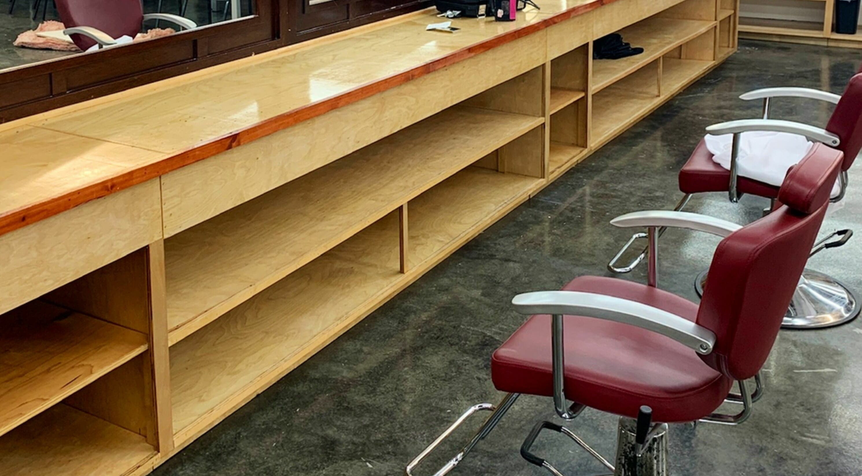 Modern salon chairs and wooden workspace at Tonsore Master Academy, San Antonio, Texas, US.