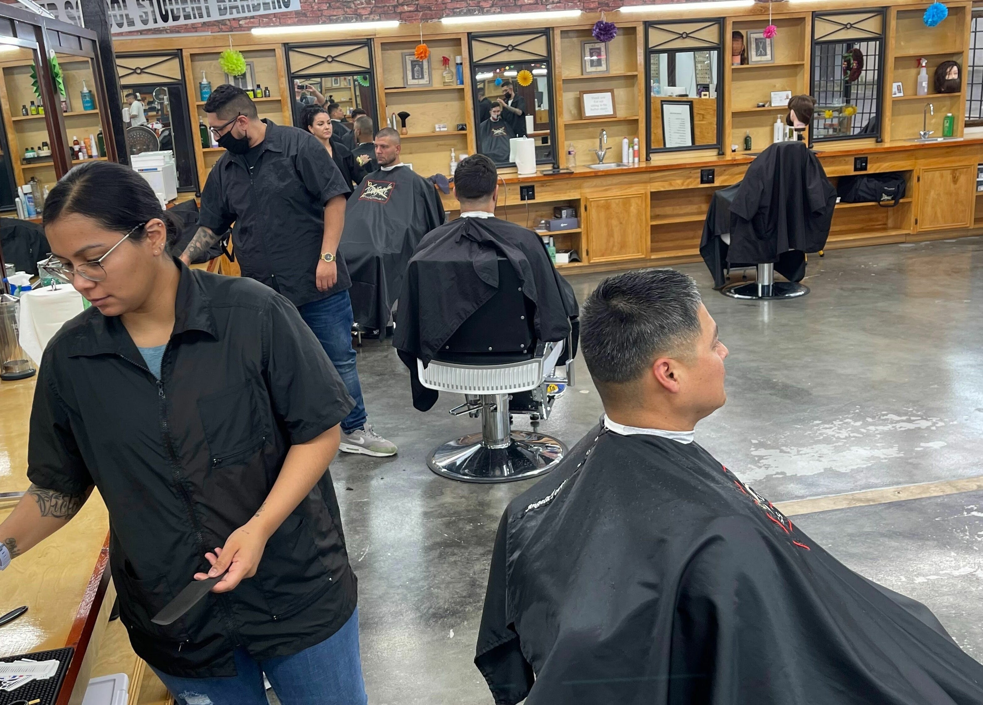 Students practice barbering at Tonsore Master Academy in San Antonio, Texas, US.