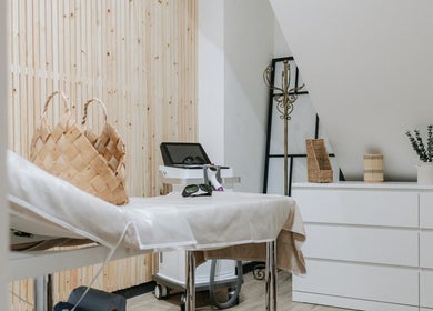 Sophia Georgiou Salon therapy room, Stockport, England, GB, featuring massage bed and calming decor.
