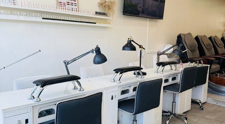 Sarang Nails manicure station in Toronto, Ontario, CA, showcasing elegant setup with chairs and lamps.