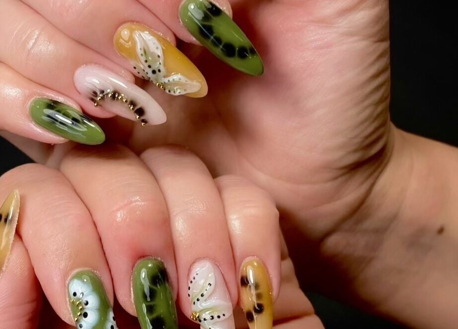 Colorful nail art at Sarang Nails, Toronto, Ontario, CA showcasing intricate designs with green and yellow hues.