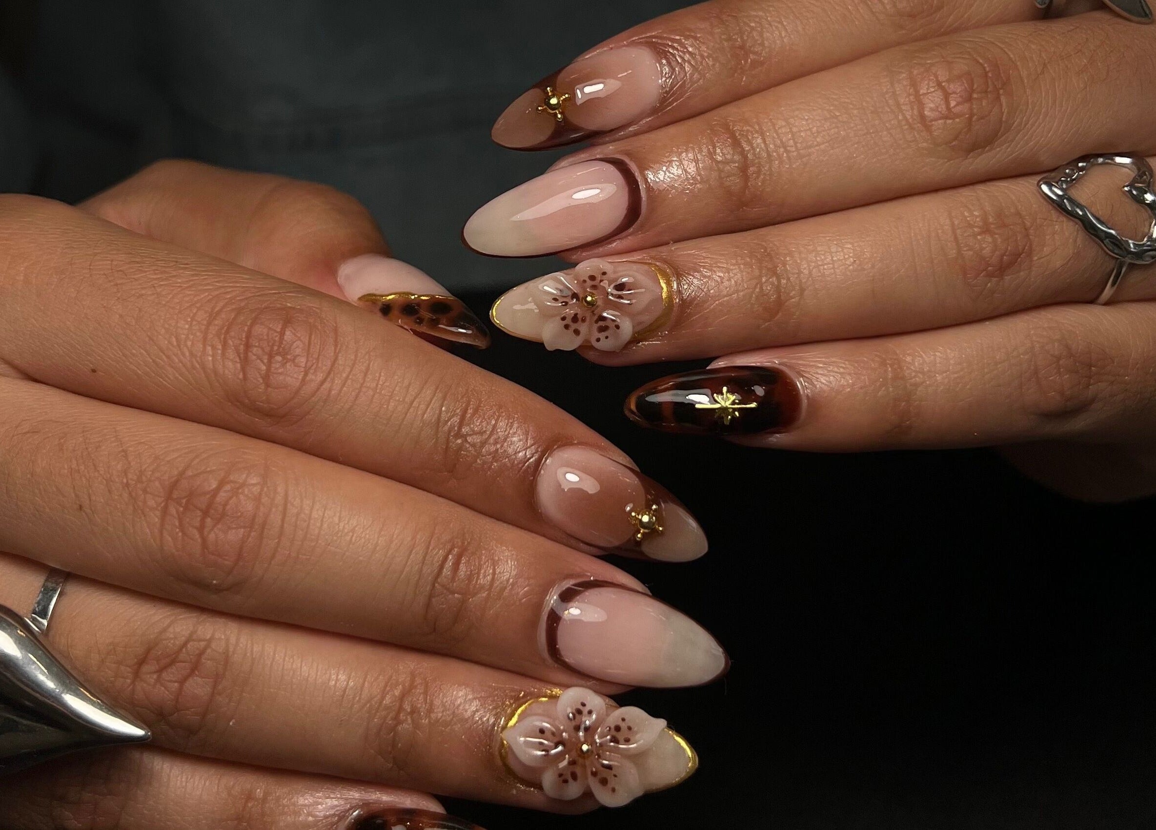 Intricate floral nail art at Sarang Nails, Toronto, Ontario, CA, showcasing elegant glossy designs.