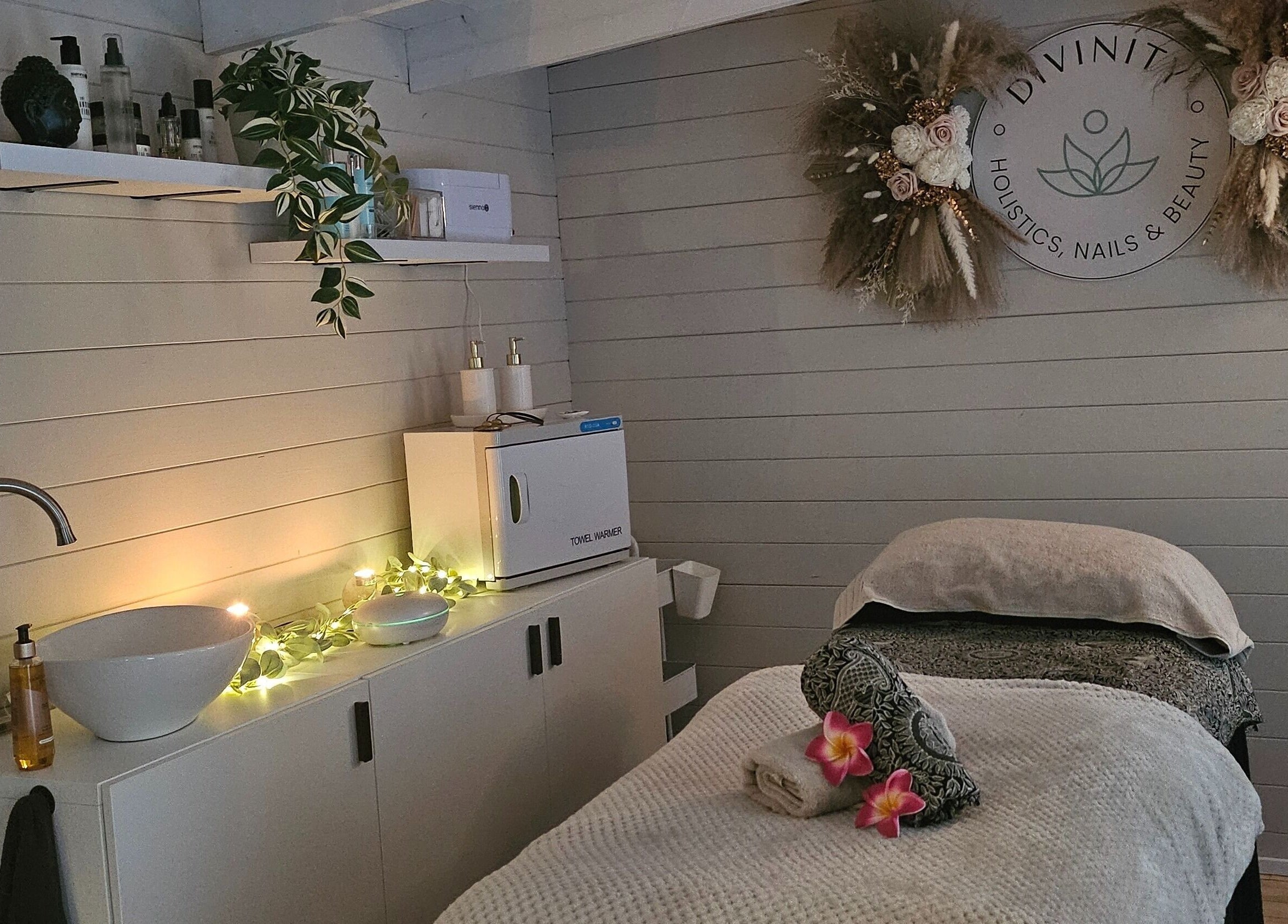Tranquil therapy room at Divinity - Holistic & Beauty Therapy, Heywood, England, GB, featuring soothing decor and a massage bed.