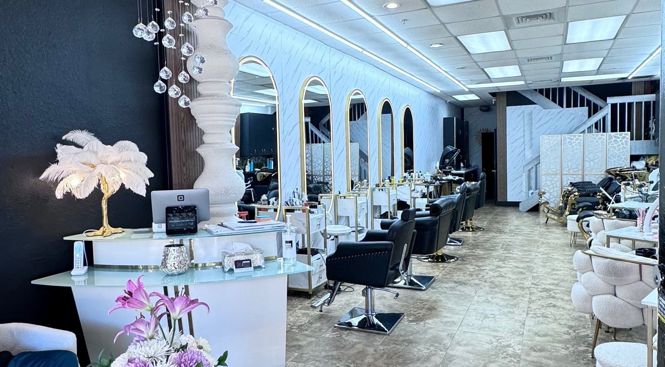 Chic interior of Cabellos Salon in Miami, Florida, US, showcasing stylish chairs and mirrors in a bright, modern setting.