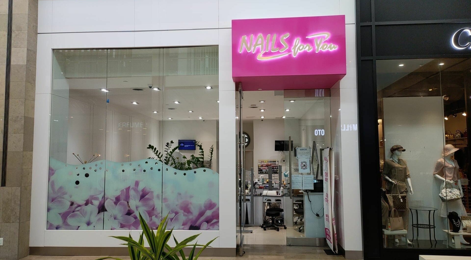 Front view of Nails For You Erin Mills in Mississauga, Ontario, CA featuring vibrant signage and floral decor.