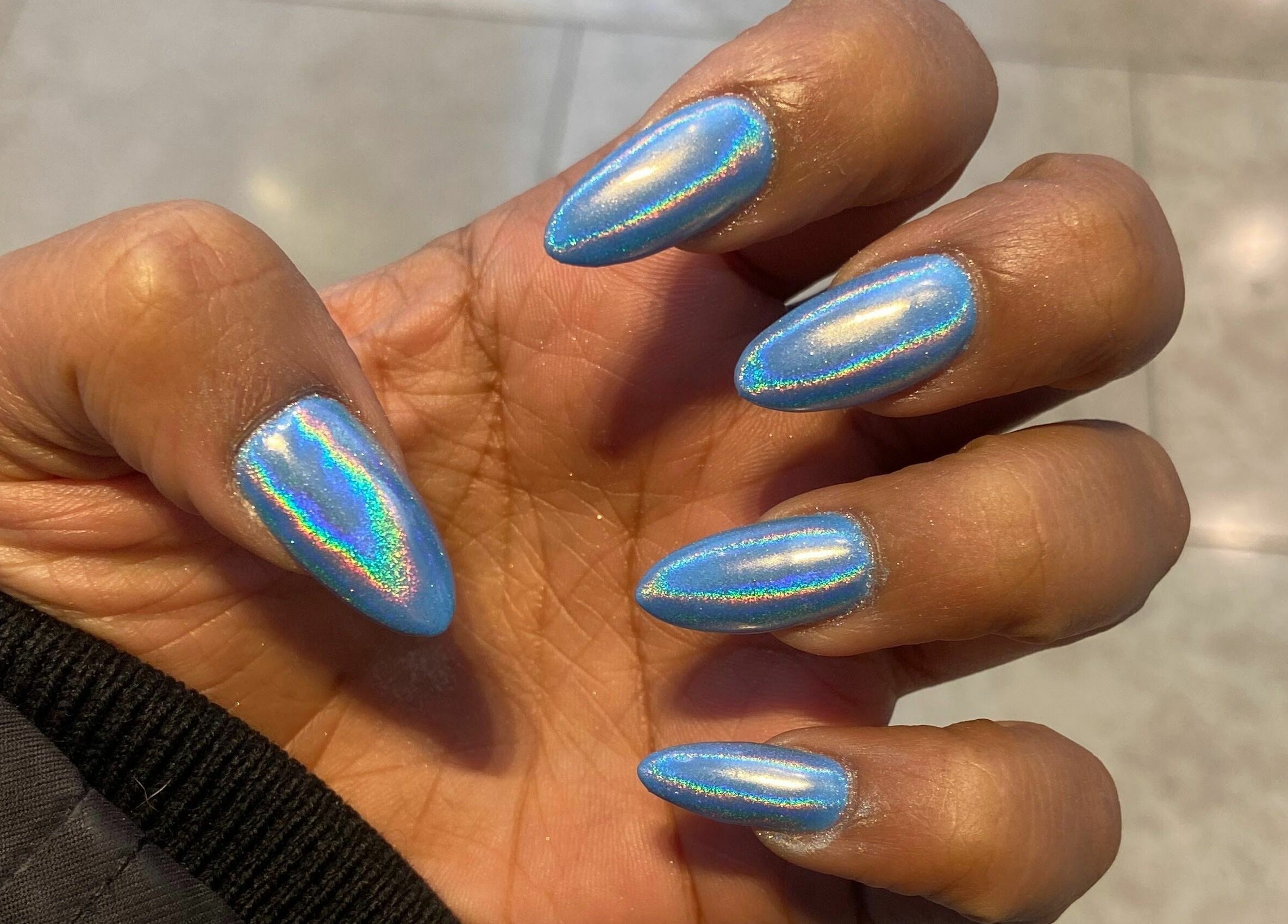 Shimmering blue nails at Nails For You Erin Mills, Mississauga, Ontario, CA. Perfect for trendy nail art lovers.