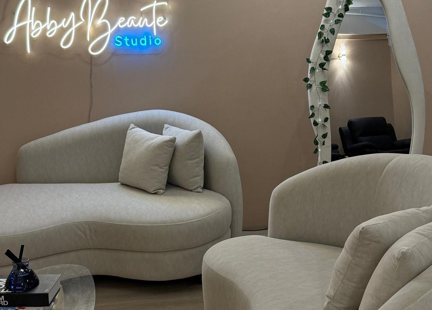 Elegant seating area at Abby Beaute Studio, Cyberjaya, Selangor, MY with cozy sofas and modern decor.