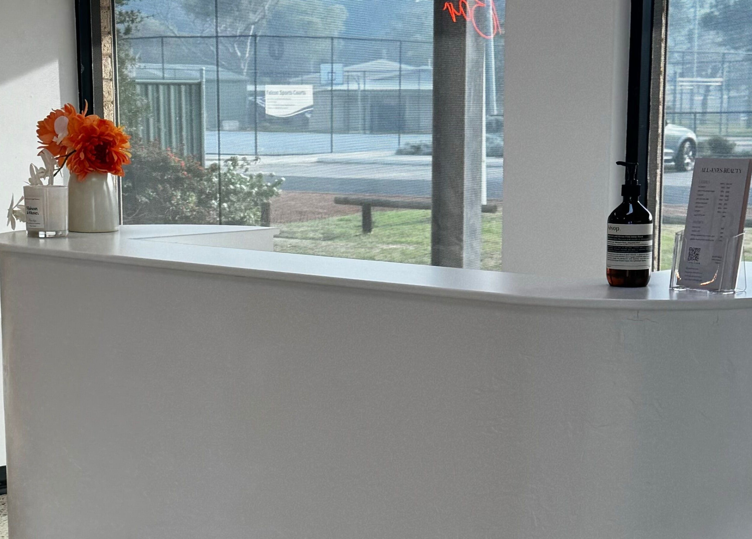 Reception at All-Eyes Beauty, Falcon, WA with elegant decor and sunlight through large windows.