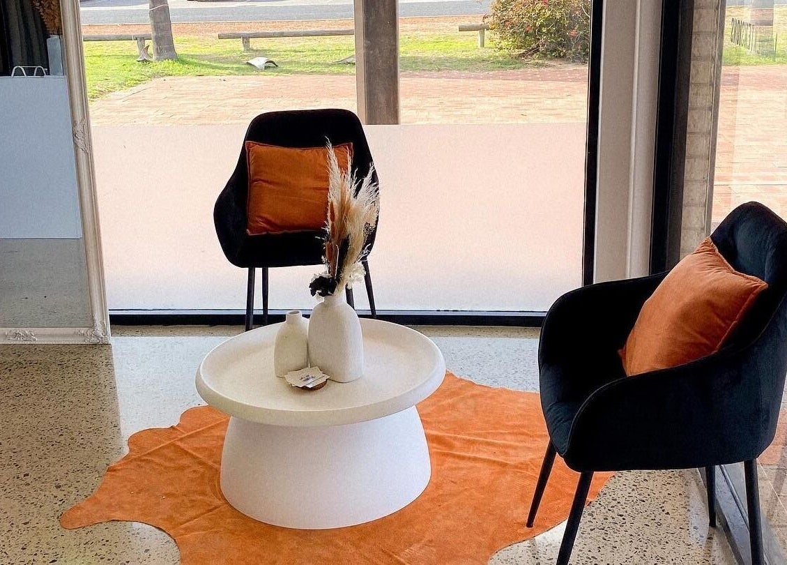 Cozy seating area at All-Eyes Beauty, Falcon, Western Australia, AU with plush chairs and a stylish table.